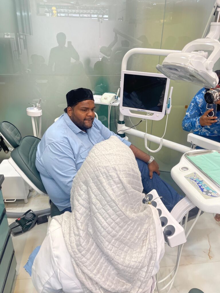 Group photo marking the successful completion of the free dental camp at Tooth Care Clinic, Zaheerabad with doctors, staff, and attendees.